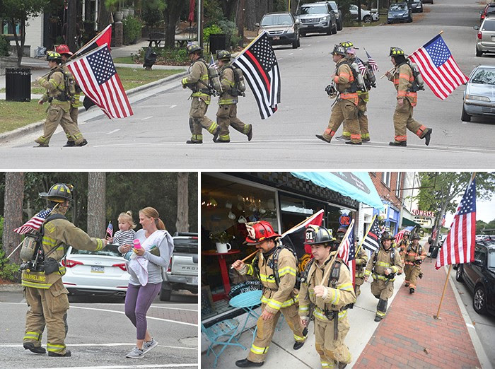Firefighters carrying flags in downtown Southern Pines