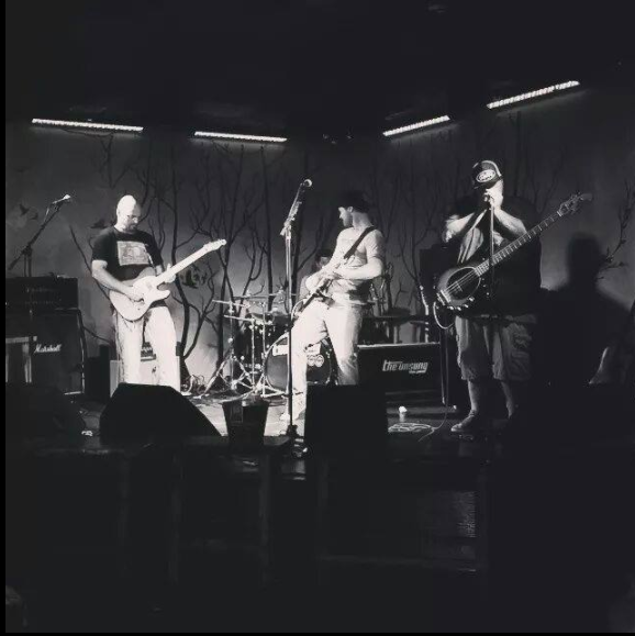 Black and white photo of band playing on stage