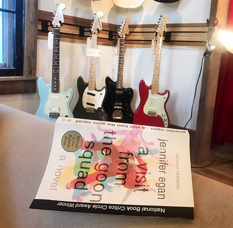 Book laying in front of guitars