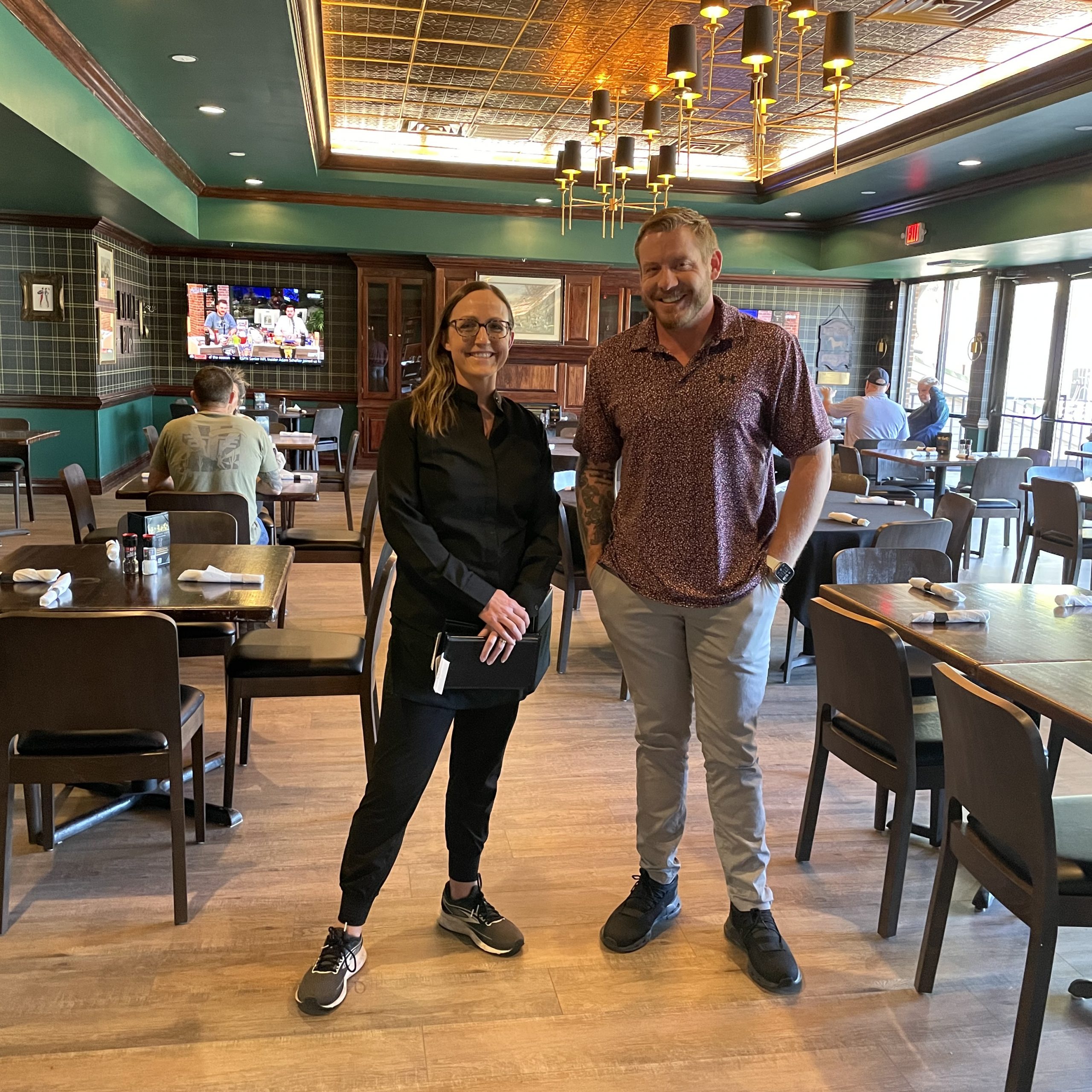 Co-owner Chase Hill with server Amanda Pribble in the Bell Tree Whispering Pines dining room